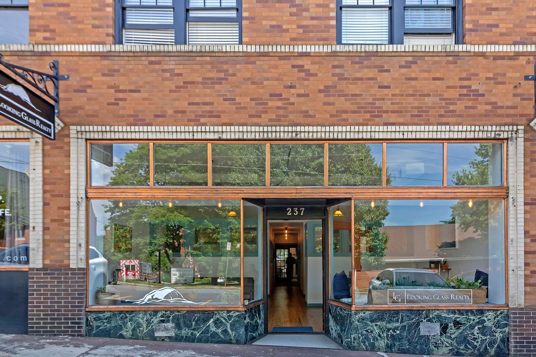 The Looking Glass Realty office storefront at 237 S Liberty St in Asheville