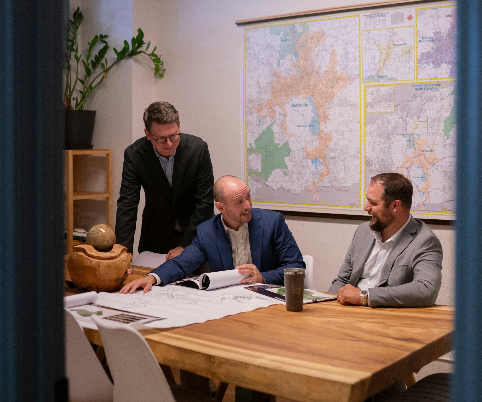 Adam, Jesse, and Scott reviewing site plans in the LGR Commercial conference room